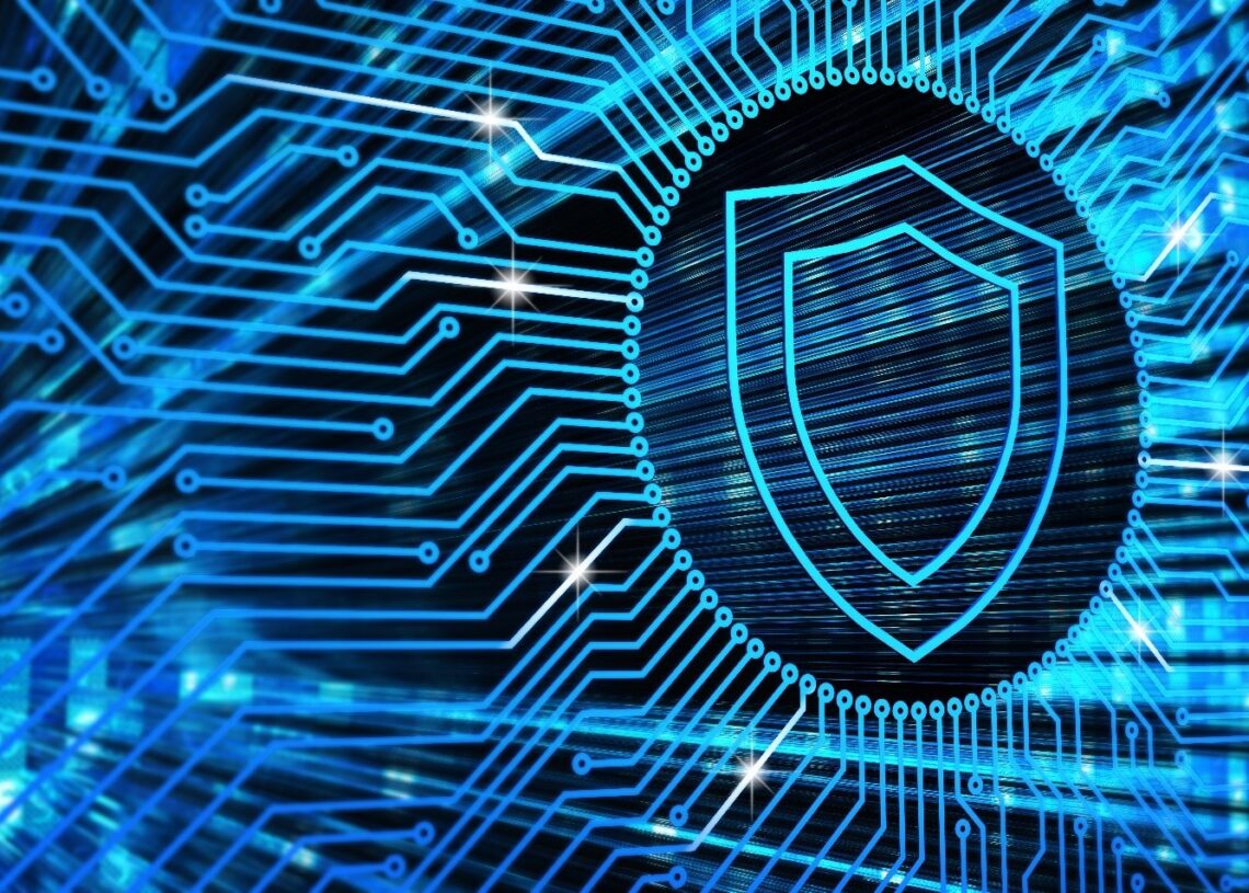 An abstract representation of digital security, featuring a bright blue shield on a background of electronic pathways.