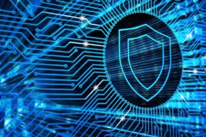 An abstract representation of digital security, featuring a bright blue shield on a background of electronic pathways.