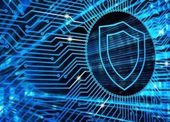 An abstract representation of digital security, featuring a bright blue shield on a background of electronic pathways.