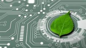 A fresh green leaf placed on an electronic circuit board with glowing lines, representing the integration of nature and technology or sustainable tech.