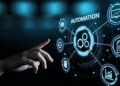 A conceptual image of process automation, where a hand interacts with a holographic interface displaying an "Automation" hub and related business process icons.